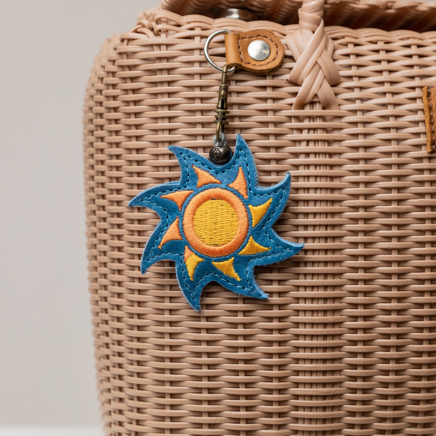 EMBROIDERED SUN CHARM - LEATHER CHARM WITH TASSEL